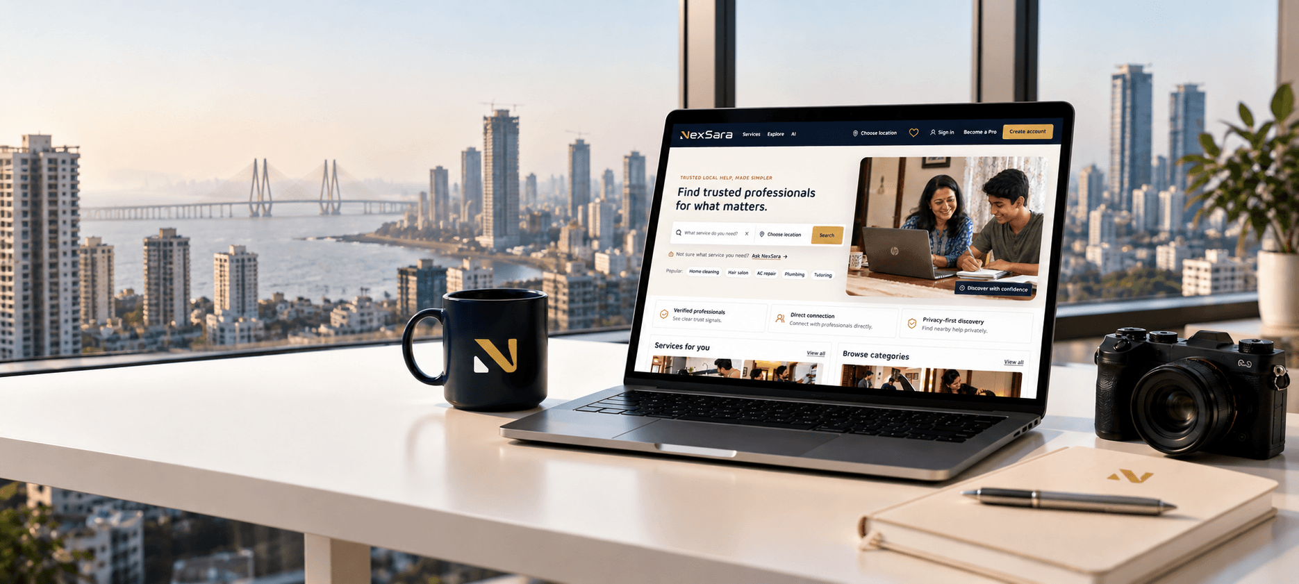 Laptop, camera, notebook, and NexSara mug in a modern editorial workspace